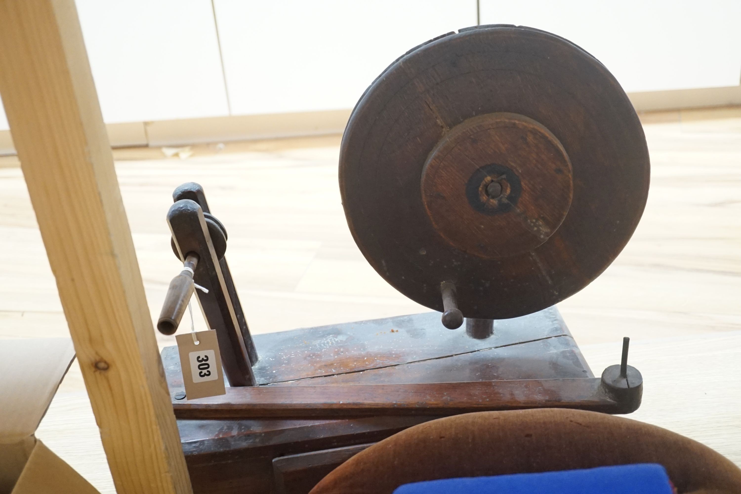 An antique lacemaker's pillow and a modern lacemaker's pillow and a lacemaker's bobbin winder